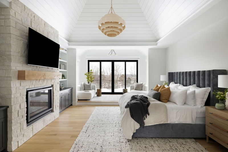 Bedroom Fireplace with Stone Wall and Vaulted Shiplap Ceiling Design