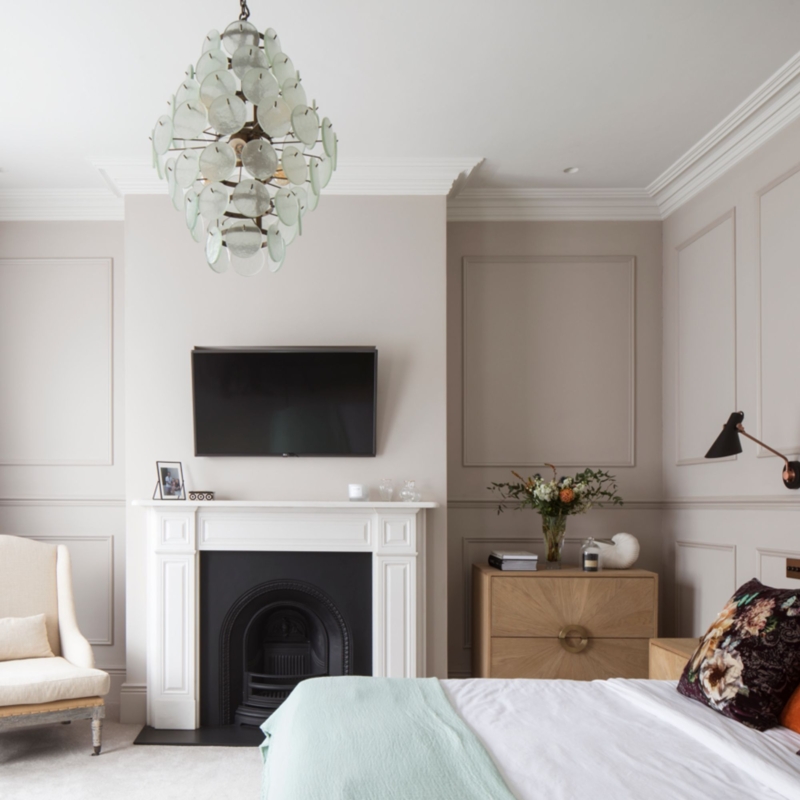 Bedroom TV Over Fireplace Design with Glass Disc Chandelier and Molding