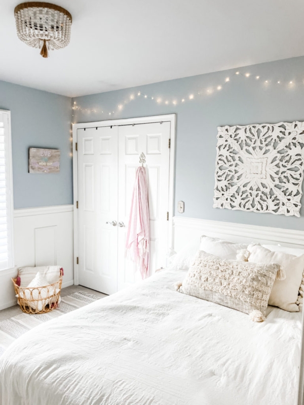 Bedroom with Beaded Chandelier and Intricate Carved Wall Art