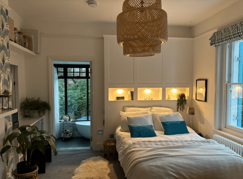 Bedroom with Built-in Headboard with Lit Niches and Woven Tiered Pendant