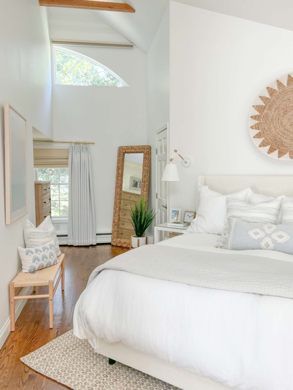 Bedroom with Vaulted Ceiling and Woven Floor Mirror Decor