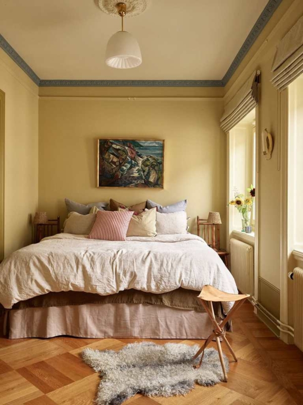 Bedroom with Yellow Walls, Blue Crown Molding, and Parquet Flooring