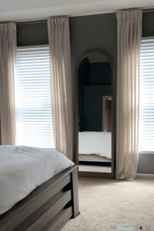 Beige Curtains Framing Arched Floor Mirror Bedroom Styling
