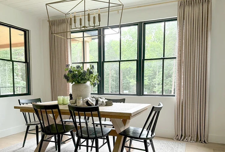 Beige Pinch Pleat Drapes framing Black Framed Windows