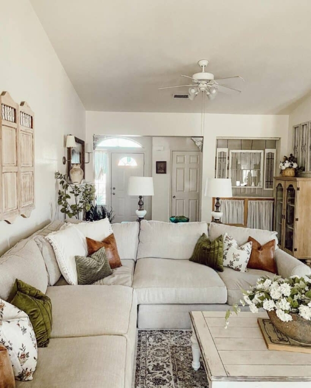 Beige Sectional Sofa with Earth Tone Accents and Whitewashed Coffee Table