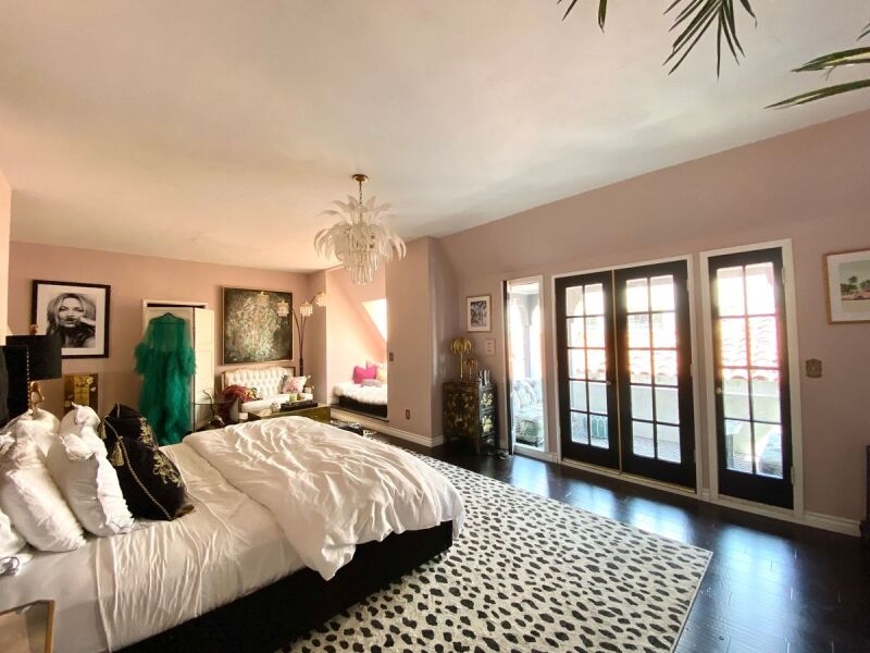 Black French Doors Bedroom with Spotted Rug and Fringe Chandelier