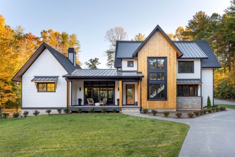 Black Metal Roof, White Siding, and Natural Wood Accent Wall