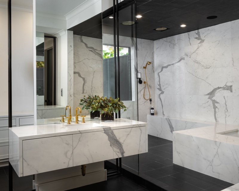 Black Paneled Ceiling with High-Contrast Marble Walls