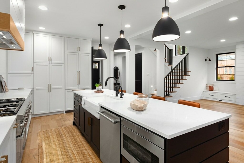 Black Pendant Lights Over Island in Modern Farmhouse Kitchen