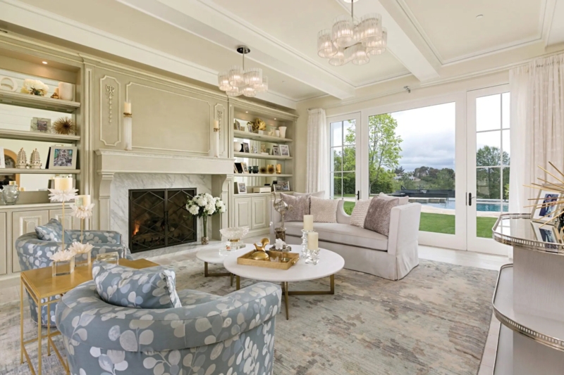 Blue Floral Armchairs with Mirrored Built-In Shelving and Fireplace