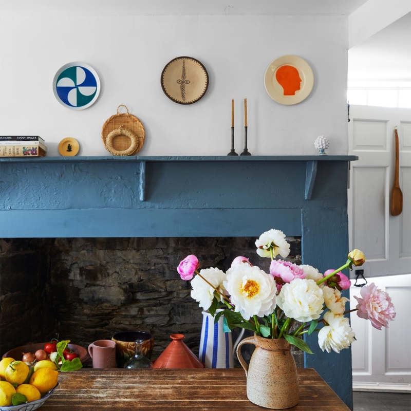 Blue Painted Mantel with Stone Fireplace & Eclectic Plate Wall Decor