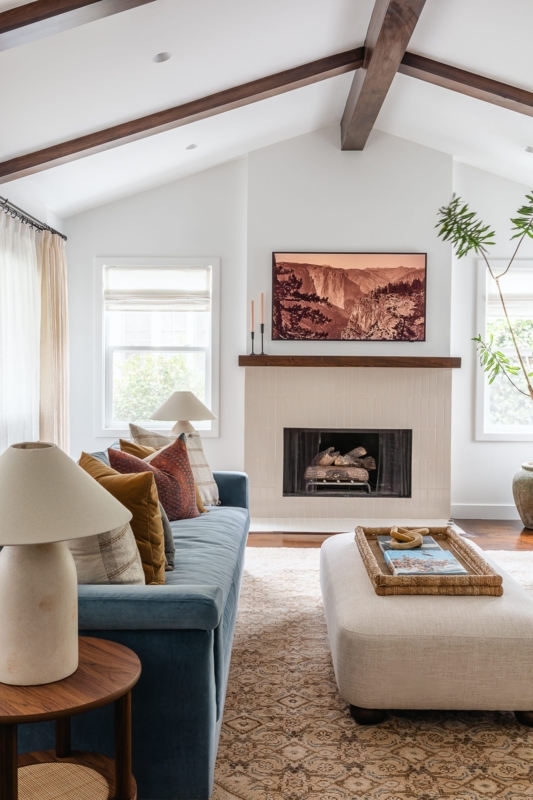 Blue Velvet Sofa In Living Room With Tiled Fireplace
