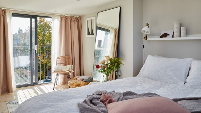 Blush Pink Floor-length Curtains and Leaning Mirror Airy Bedroom