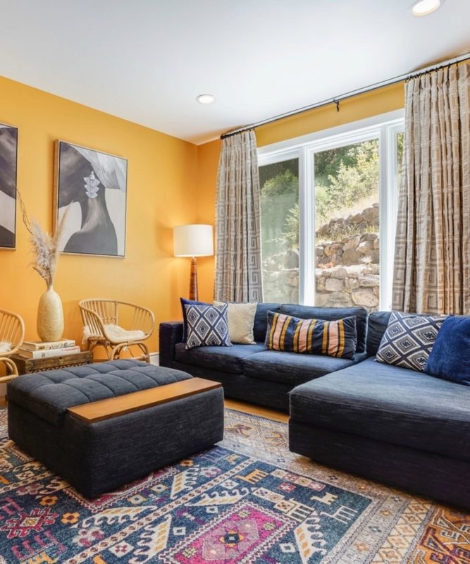 Bohemian Patterned Drapes against Bold Orange Accent Wall