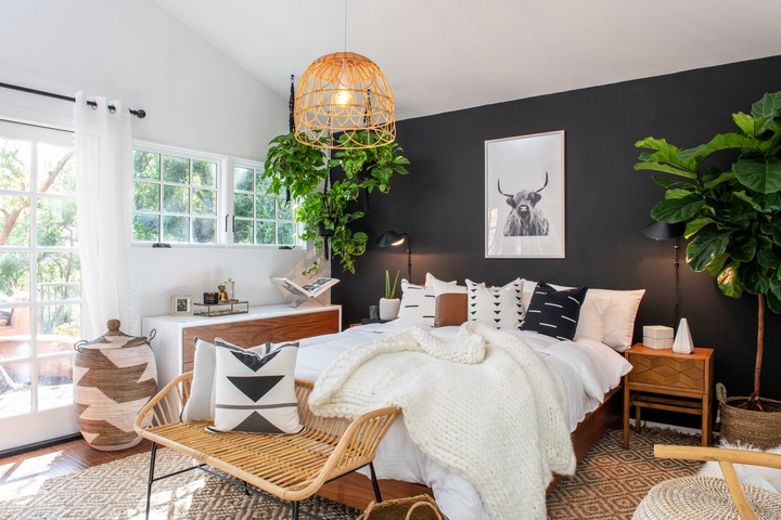 Boho Bed Styling against Black Accent Wall with Woven Rattan Bench