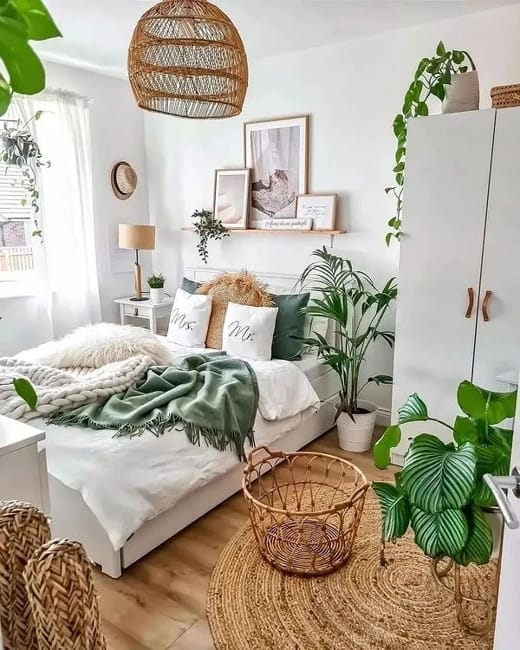 Boho Bed with Sage Green Throw, Woven Rattan Pendant, and Potted Plants