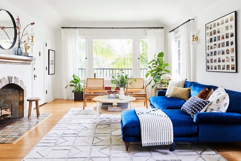 Bold Blue Sectional Sofa Styling near an Arched Brick Fireplace