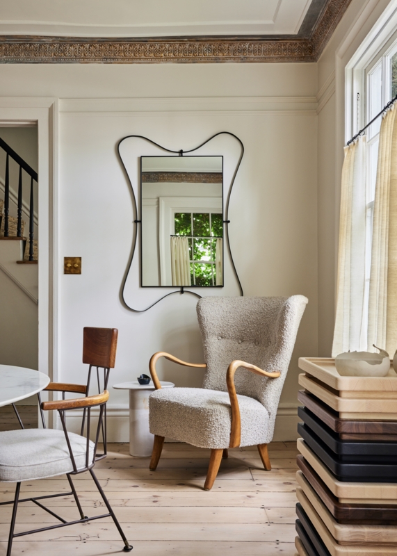 Bouclé Wingback Chair with Curved Wood Arms in a Cozy Reading Nook