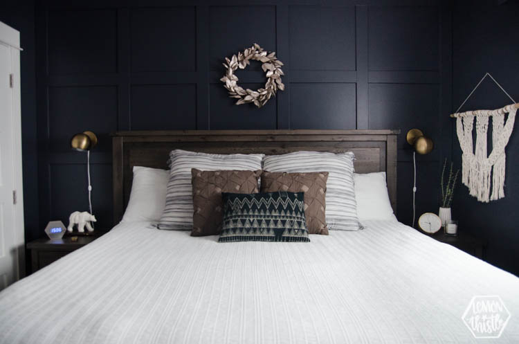 Brass Globe Sconces Bedroom Styling over Navy Paneled Wall