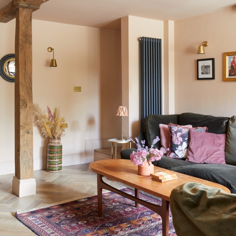 Brass Wall Sconces with Herringbone Floor in Eclectic Living Room