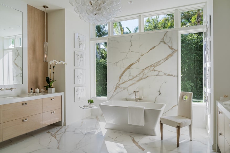 Bright Luxury Master Bath with Marble Focal Wall and Bubble Chandelier