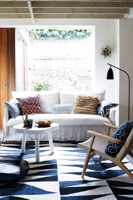 Bright Sunlit Living Room Navy Geometric Rug White Slipcovered Sofa