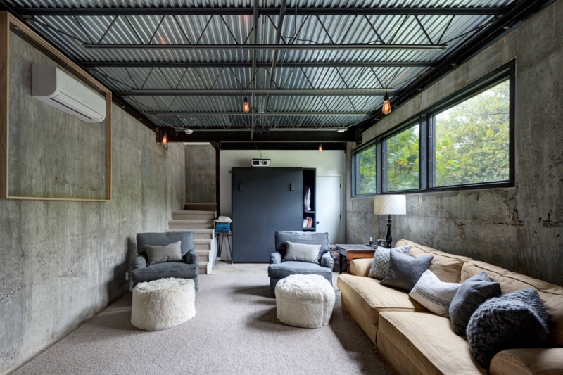 Brutalist Sofa Lounge with Corrugated Metal Ceiling and Concrete Walls