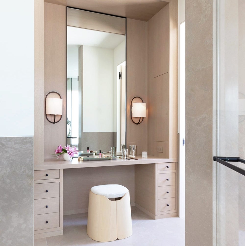Built In Makeup Vanity with Symmetrical Sconces and Wood Cabinets