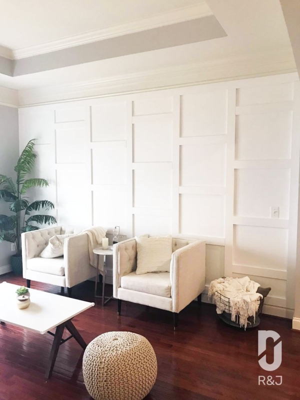 Button Tufted Accent Chairs against Staggered Box Grid Wall Molding