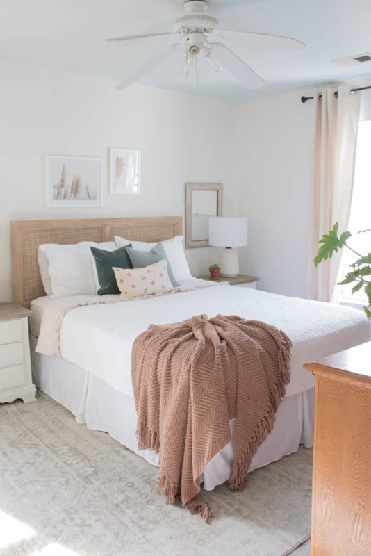 Cane Headboard Bed in Boho Transitional Bedroom with Mauve Knit Throw