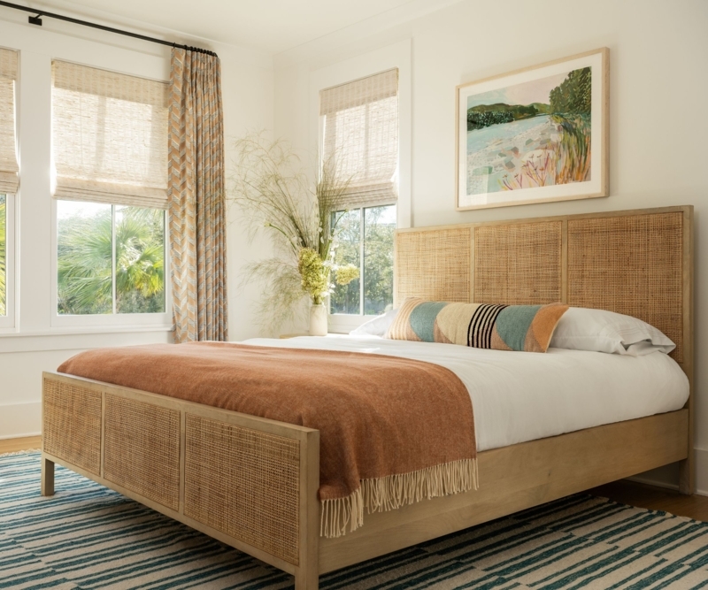 Cane Panel Bed Frame with Terracotta Throw and Teal Striped Rug