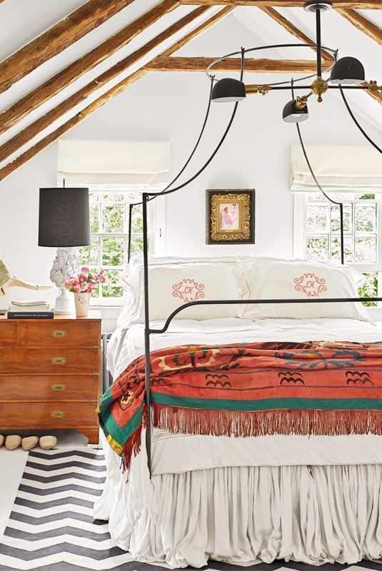 Canopy Bed Arched Frame in Attic Bedroom with Exposed Beams