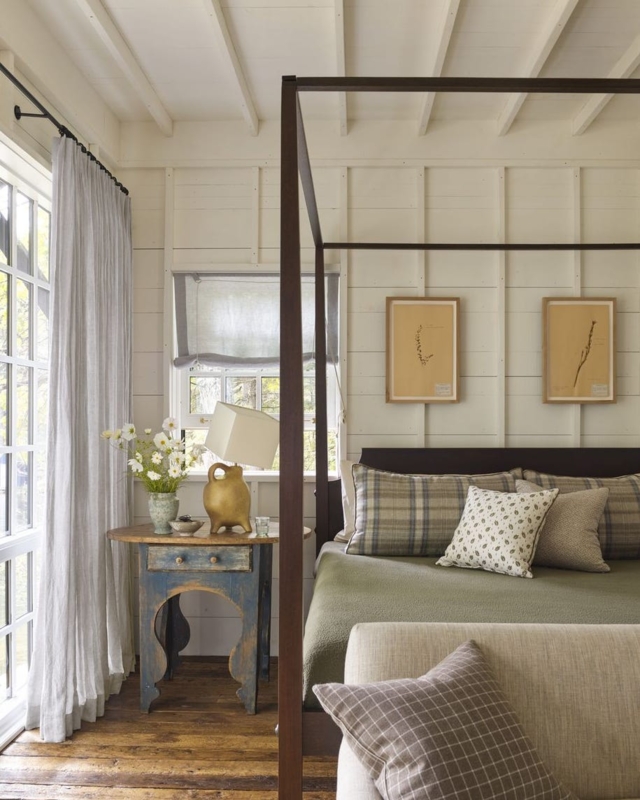 Canopy Bed with Minimal Dark Frame and Blue Distressed Nightstand