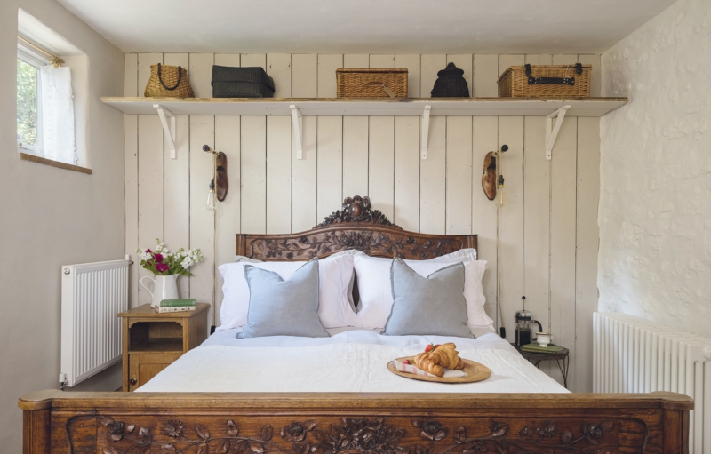 Carved Wood Bed Frame with Ornate Floral Relief and Cream Paneling