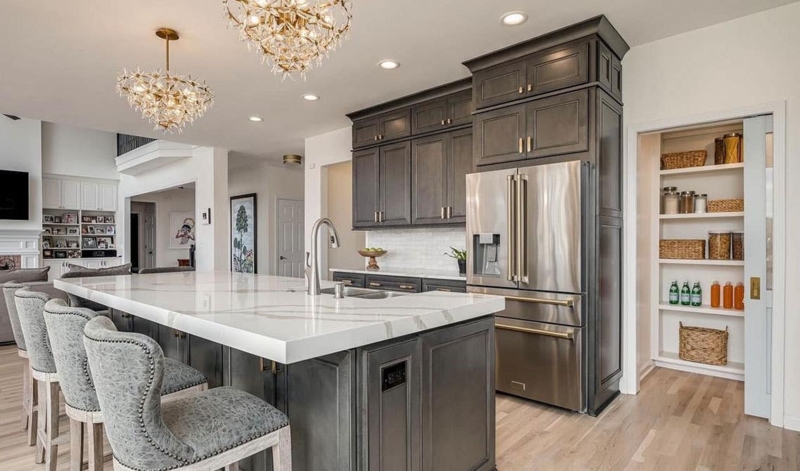 Charcoal Kitchen Cabinets with Floral Chandeliers & Gold Hardware