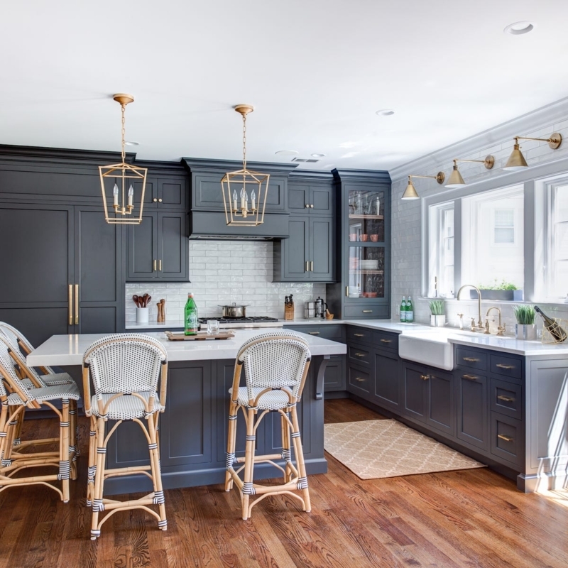 Charcoal Kitchen Cabinets with Gold Hardware and Woven Stools