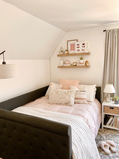 Charcoal Tufted Daybed with Blush Pink Bedding and Floating Shelves
