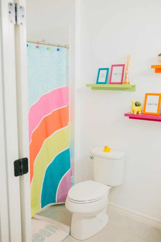 Cheerful Bathroom with Rainbow Shower Curtain and Colorful Shelves