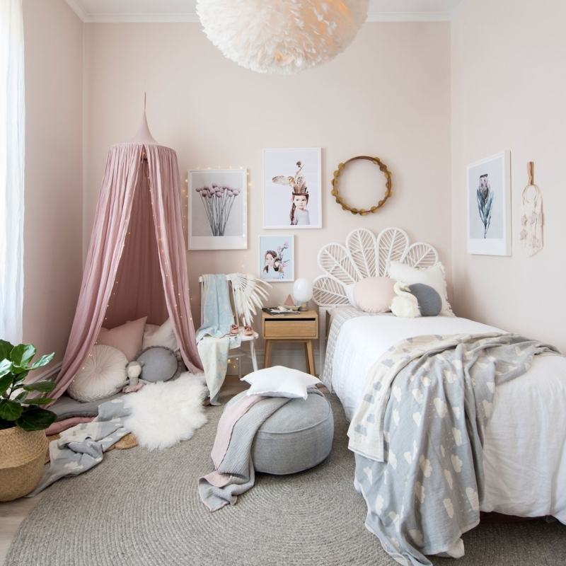 Chic Girls Bedroom with a White Fan Headboard and Feather Pendant