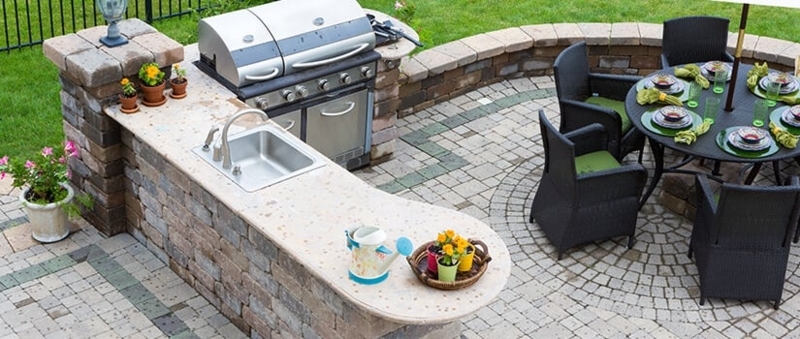 Circular Paver Patio Design with Curved Stone Countertop Kitchen