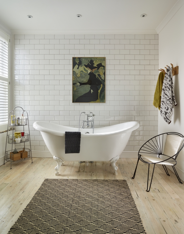 Clawfoot Bathtub Setting: Woven Rug against Subway Tile Backdrop
