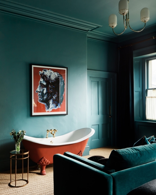 Clawfoot Bathtub with Red Tub Accent and Teal Monochromatic Walls