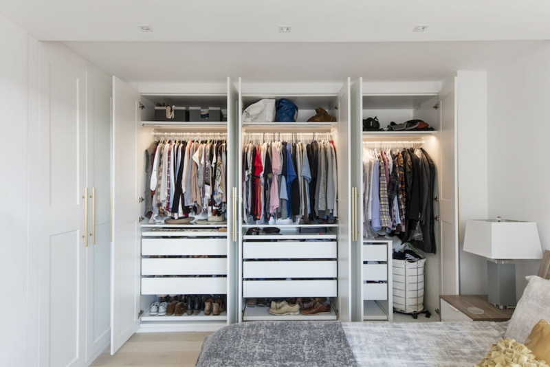 Closet System featuring Gold Vertical Handles and Integrated Lighting