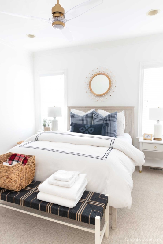 Coastal Bed featuring White Bedding with Navy Piping and Woven Bench