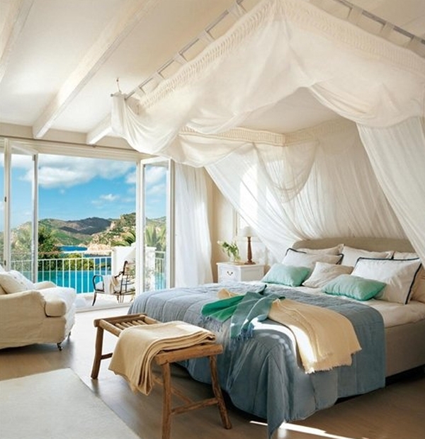 Coastal Canopy Bed with Billowy White Drapes and Scenic Sea View
