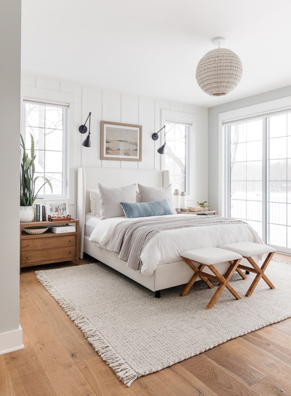 Coastal Lake House Bedroom with Vertical Wall Paneling and X-Base Stools