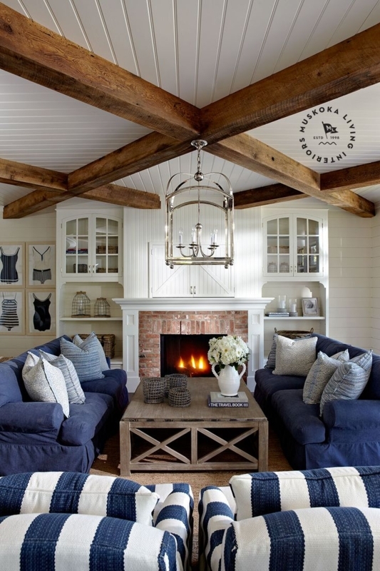 Coastal Living Room with Exposed Wood Beams & Symmetrical Navy Sofas