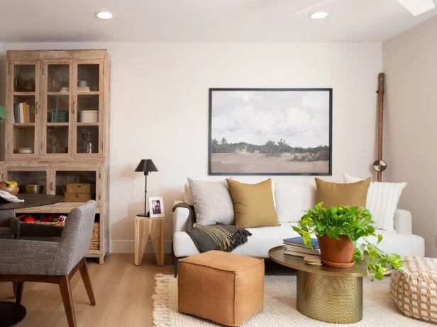 Coastal Modern Living Room with Brass Drum Coffee Table and Rustic Hutch