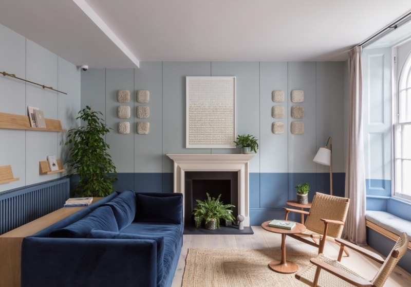 Coastal Sofa with Two-Tone Blue Walls and Woven Accent Chairs