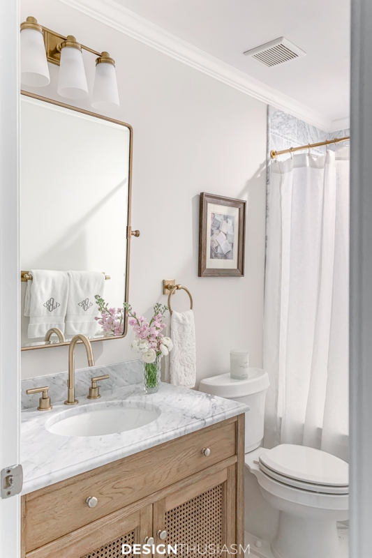 Compact Bathroom with Woven Cane Vanity Doors and Marble Top